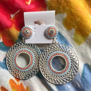 A silver,green,blue,and orange circular earringset